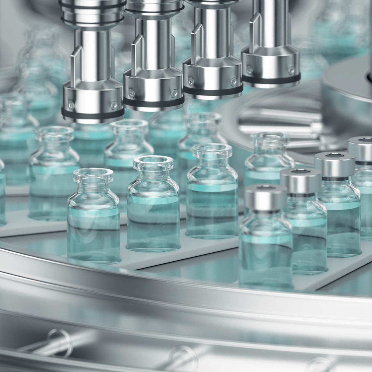 Manufacturing equipment filling dozens of Astellas medicine bottles.